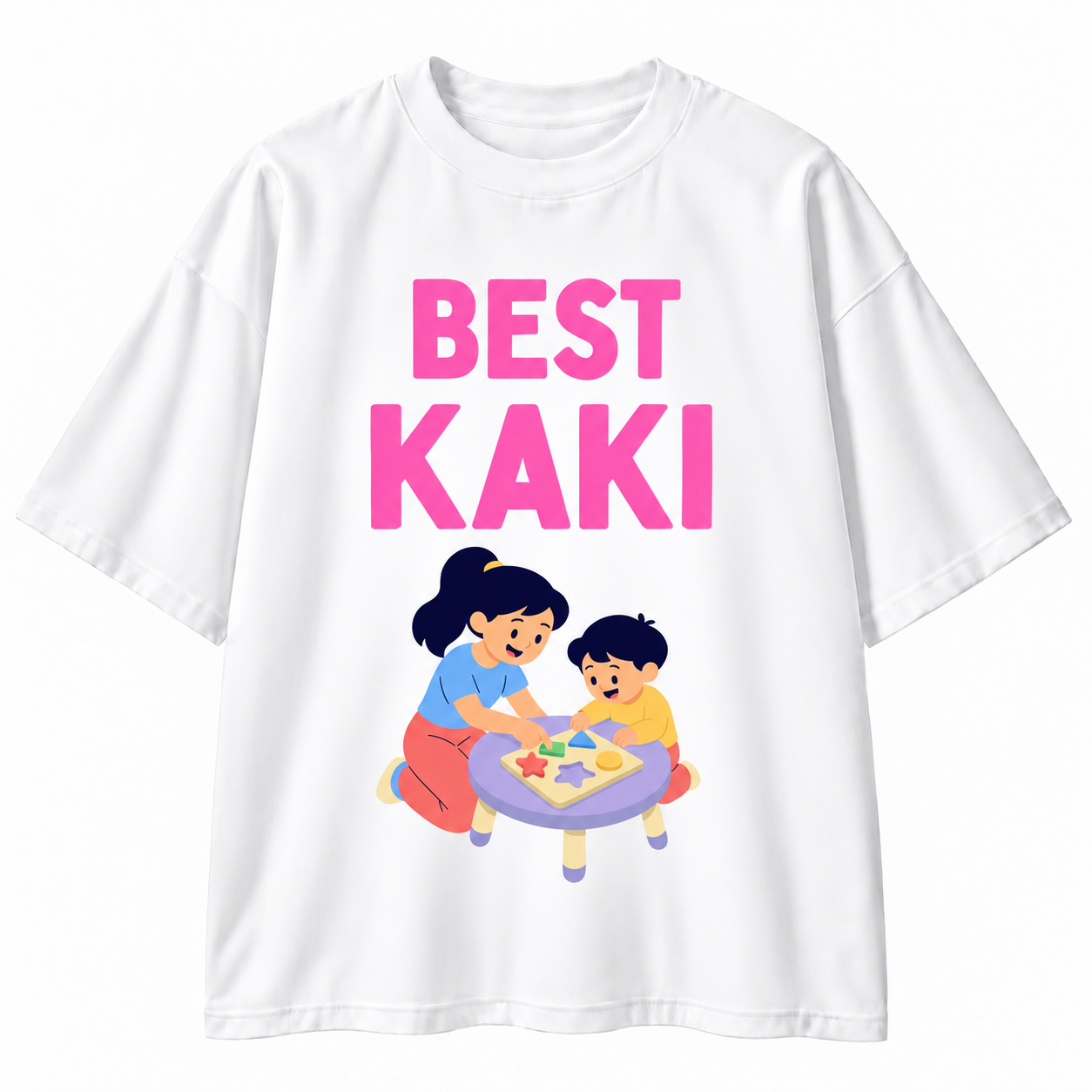A white short-sleeve t-shirt with a graphic print that reads 'BEST KAKI' in bold pink letters above an illustration of a woman and a child playing with star-shaped toys at a small table.