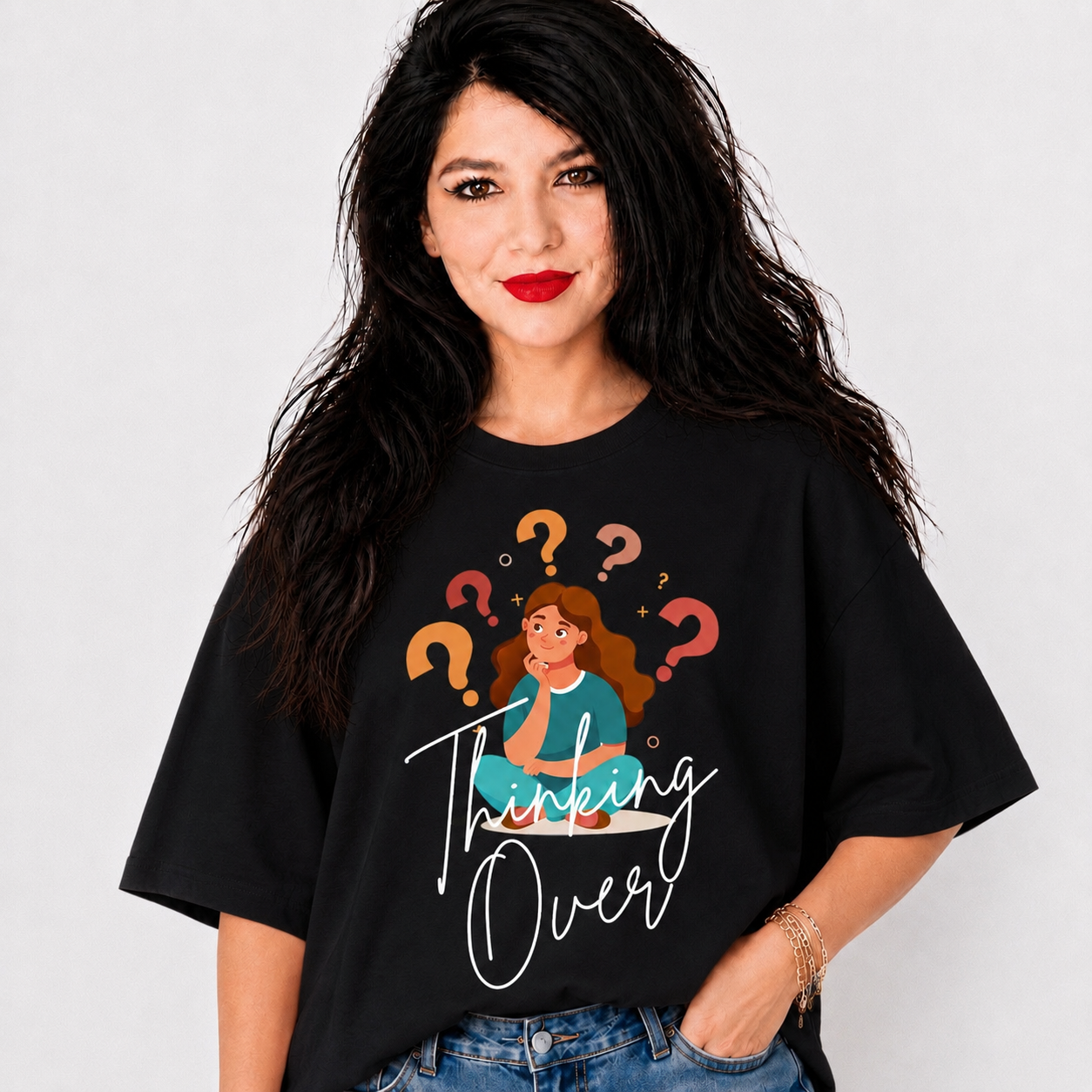 A woman wearing a black oversized graphic t-shirt with a cartoon illustration of a woman surrounded by question marks and the text 'Thinking Over'.